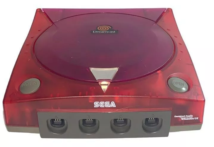 Translucent red SEGA Dreamcast console with gray buttons labeled "Power" and "Open." Visible logos include Dreamcast and Windows CE.